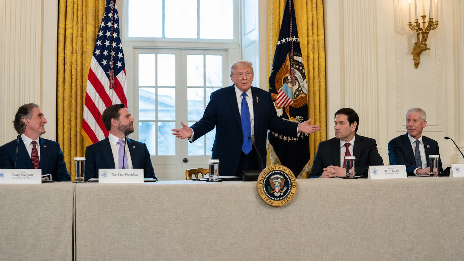 Donald Trump speaks between senior U.S. officials at a formal White House oil-industry meeting