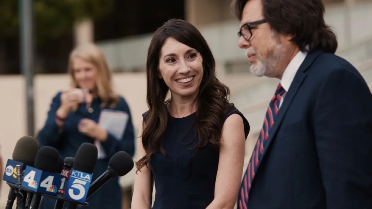 Michelle Hadley smiles beside her attorney while speaking to reporters after her exoneration.