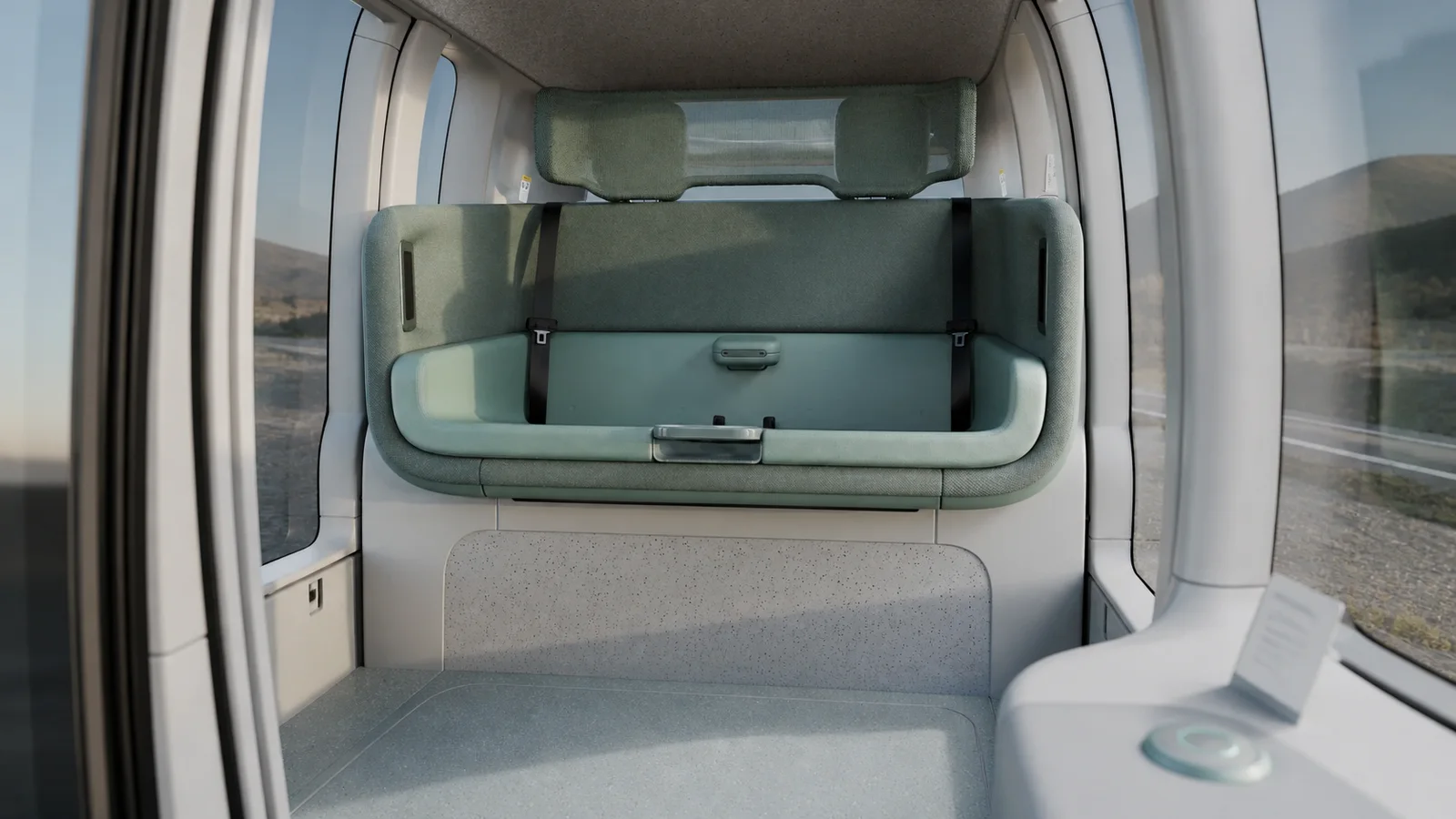 The Zoox robotaxi cabin with face-to-face seating and no driver controls visible.