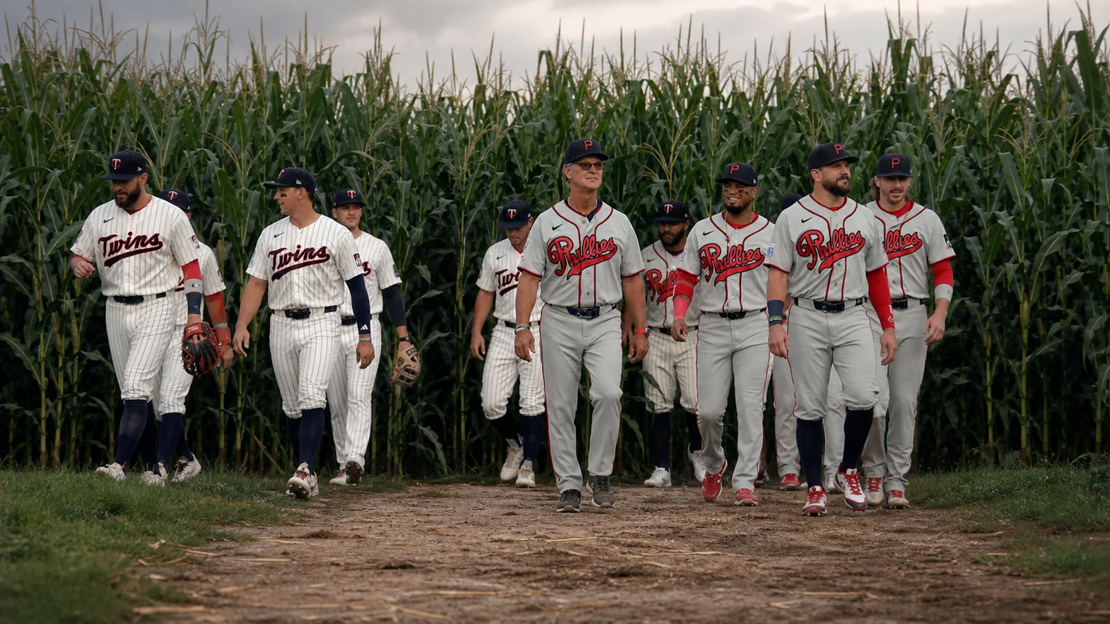 Phillies and Twins players in retro uniforms emerging from the cornstalk entrance at Field of Dreams