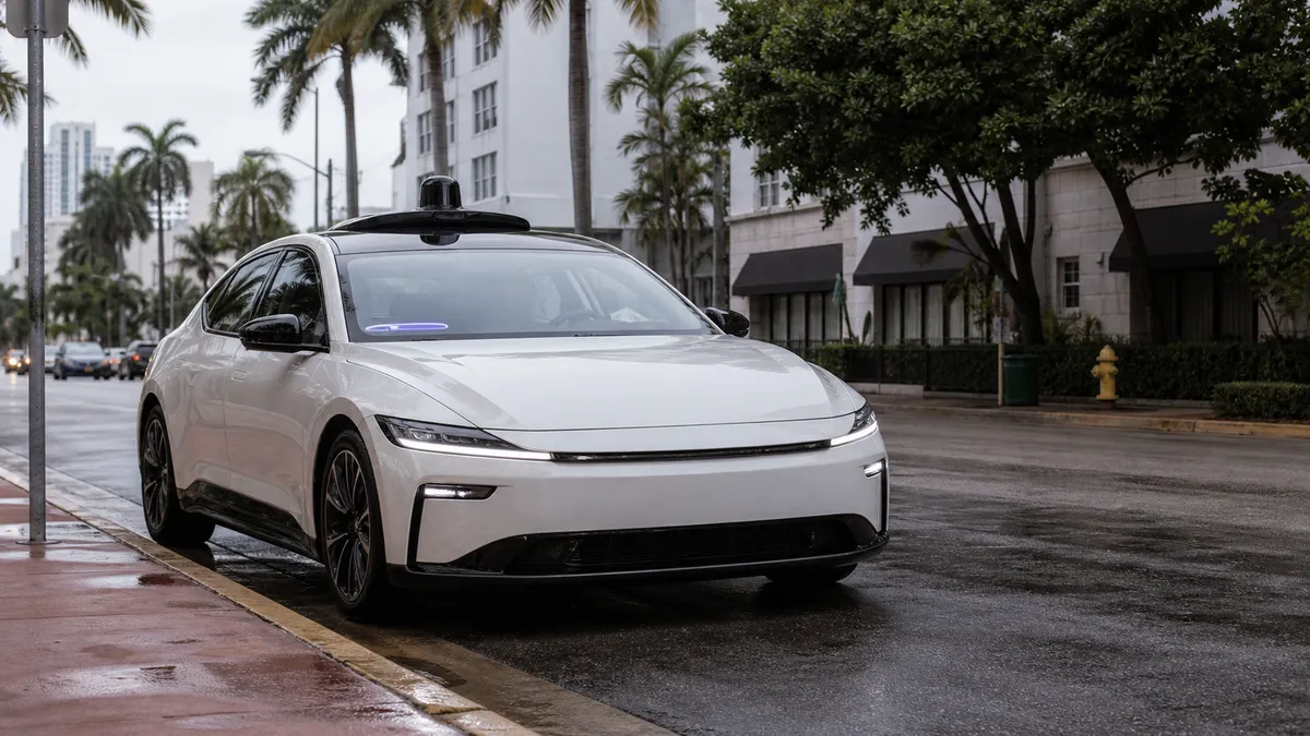 Generic editorial image of an autonomous electric car at a Miami curb on a rainy street
