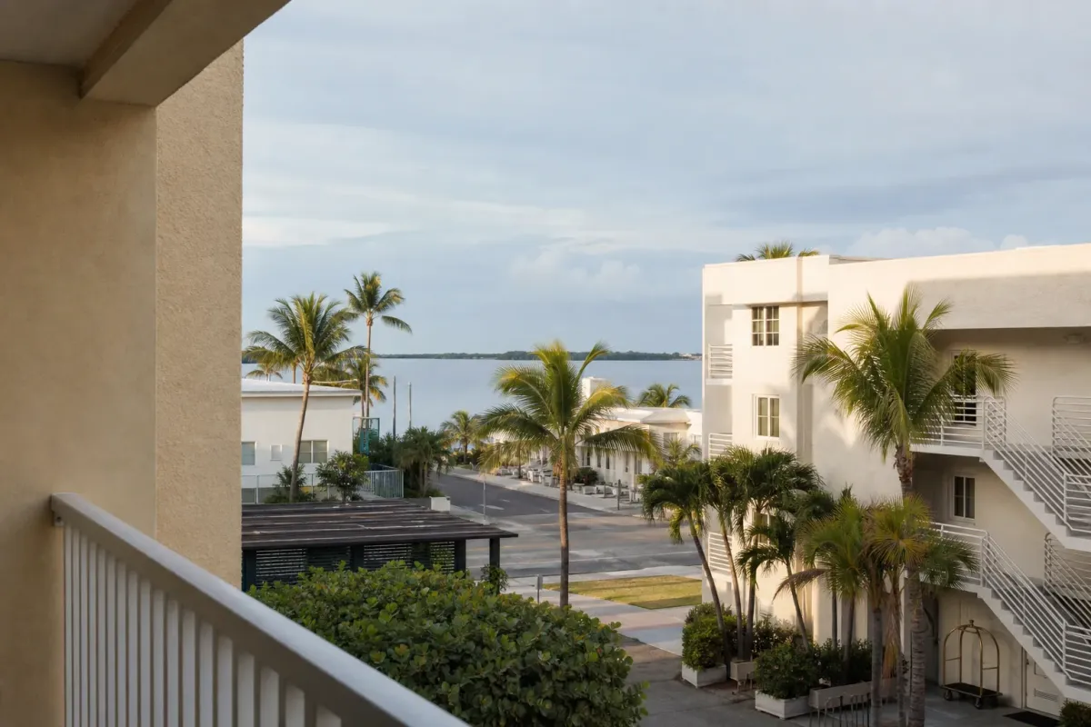 A coastal South Florida neighborhood with palm trees and low-rise vacation rental buildings.