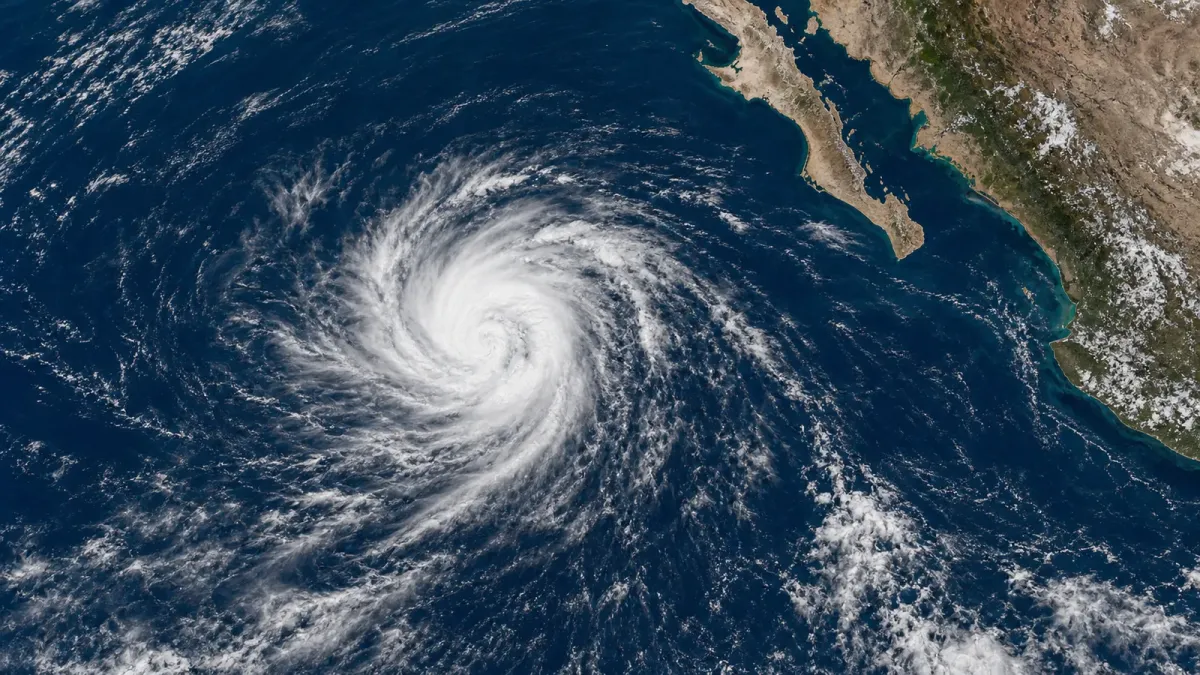 Satellite-style editorial image of Tropical Storm Elida over the eastern Pacific, far southwest of Baja California