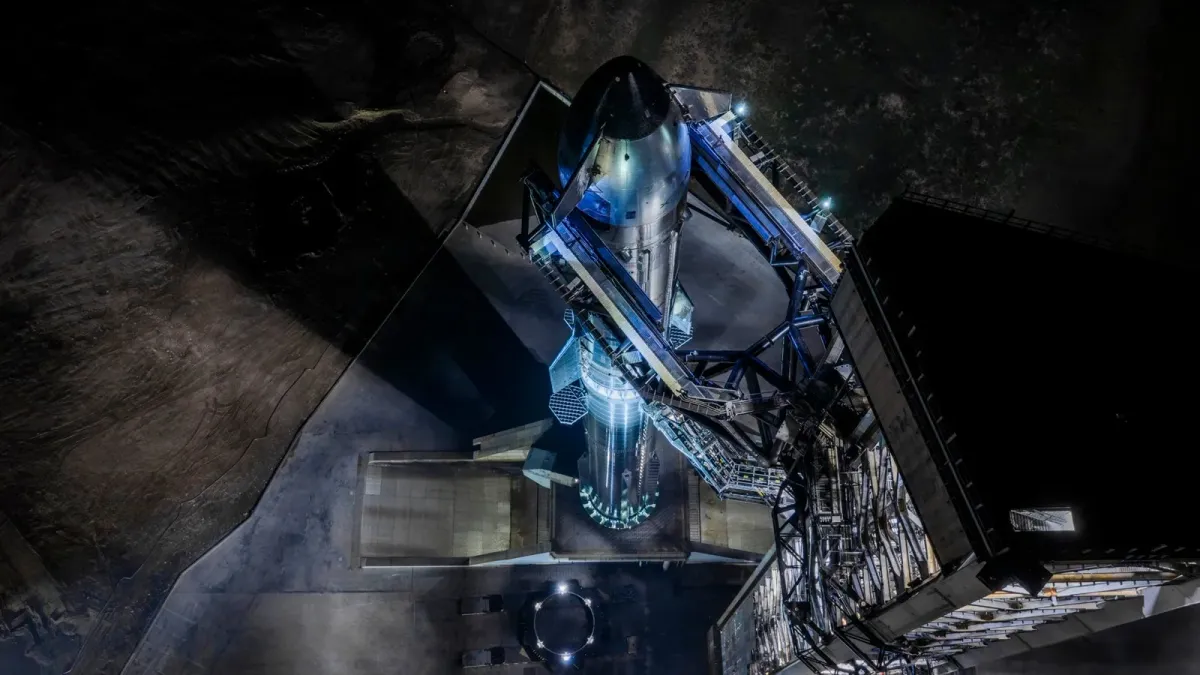 Starship standing on the Starbase launch mount at night in an official SpaceX source-photo crop.