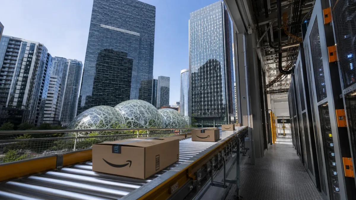 Amazon's Seattle Spheres behind a fulfillment conveyor leading toward physical cloud infrastructure
