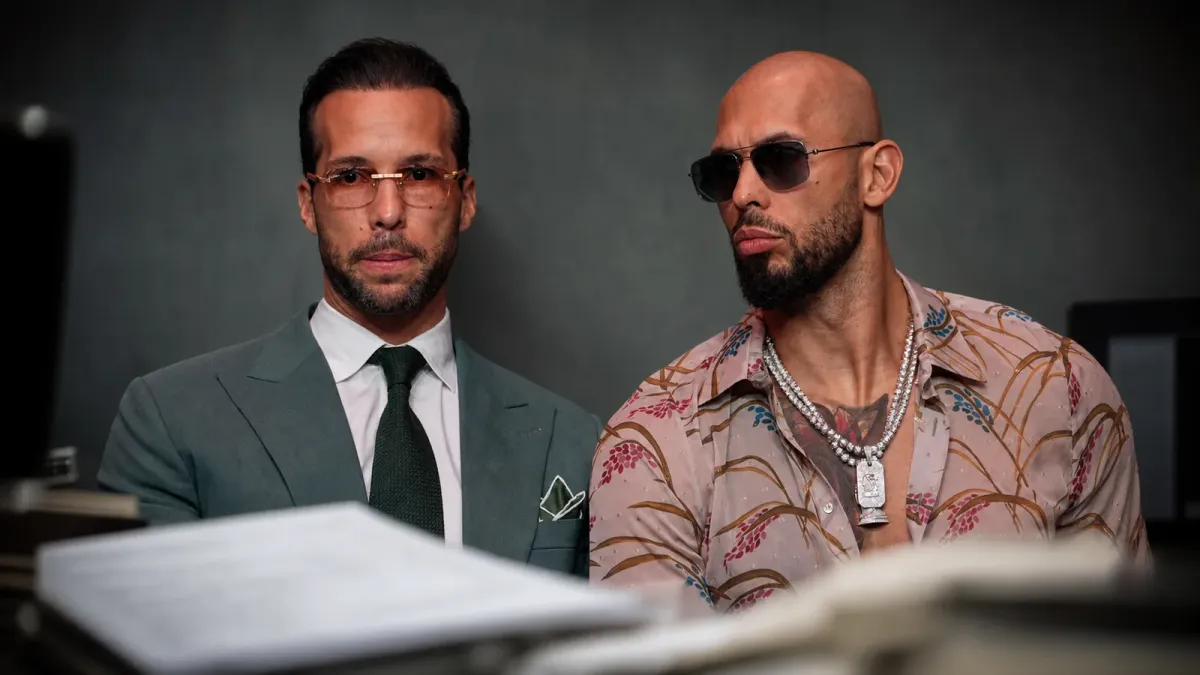 Andrew Tate and Tristan Tate in a neutral editorial portrait with blurred extradition paperwork in the foreground