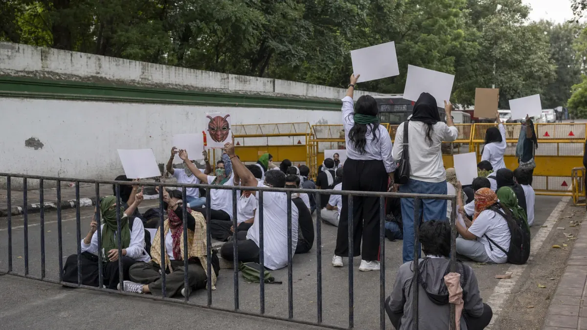 Cockroach Janta Party protesters gathered behind barricades at a transformed New Delhi sit-in scene.