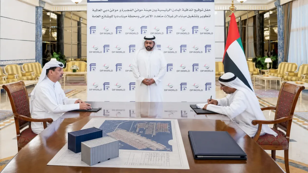 DP World and Fujairah Ports Authority signing backdrop with cargo-planning objects on a table