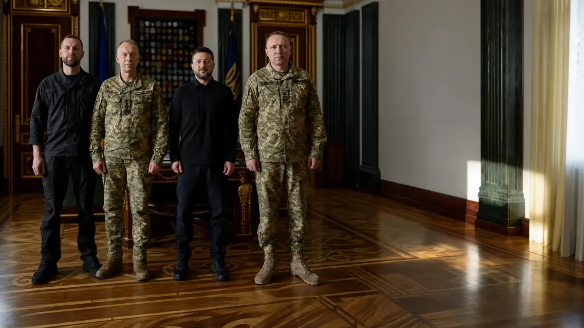 Zelenskyy stands with Ukrainian military commanders in an official room during a command transition.