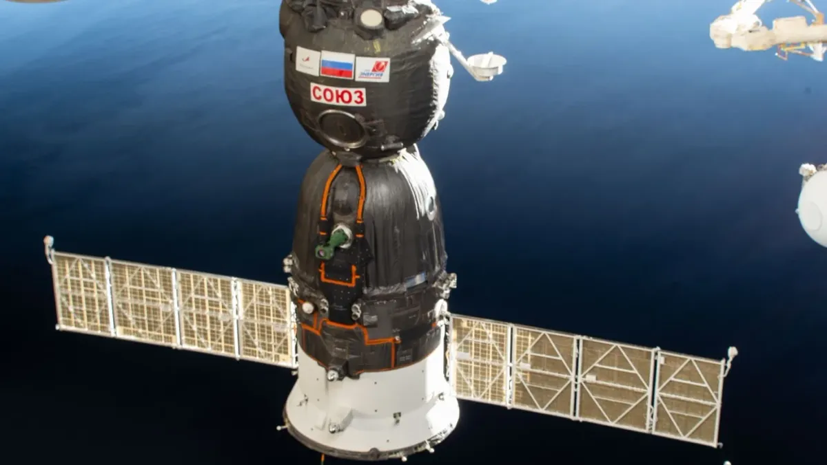 The Soyuz MS-28 spacecraft docked to the International Space Station above Earth