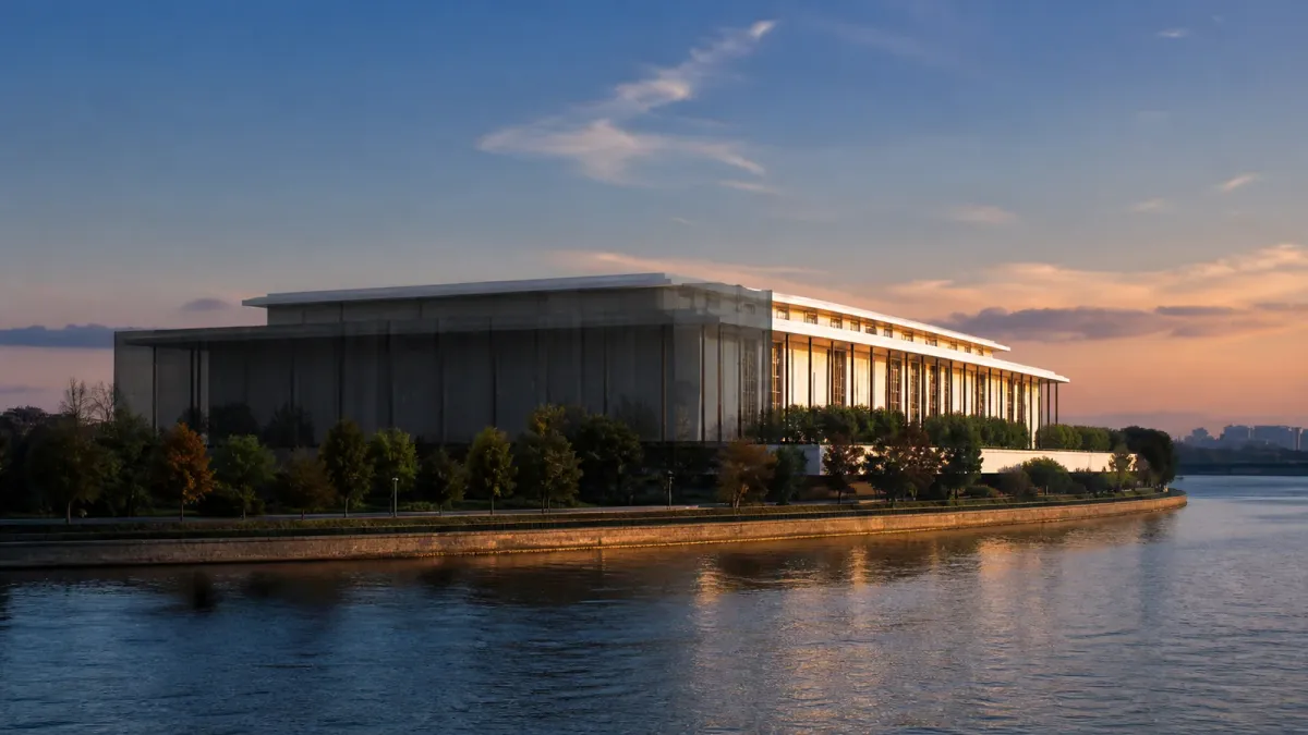 An editorial view of the Kennedy Center beside the Potomac, with most of the building behind a translucent dark veil and one edge left in warm light