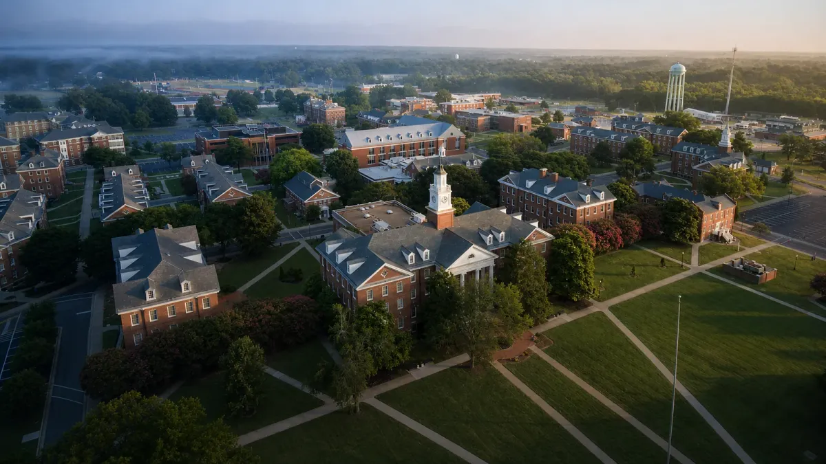Aerial view of Virginia State University's red-brick campus transitioning from predawn blue-gray to soft morning light