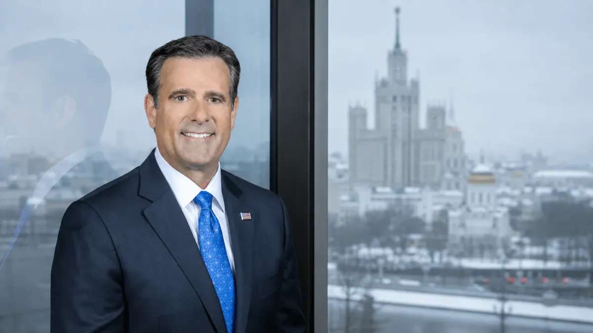 CIA Director John Ratcliffe in a source-grounded portrait treatment beside a distant, softly focused Moscow skyline.