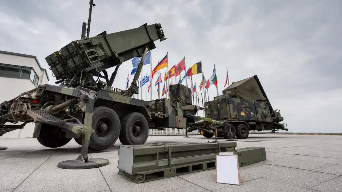 A NATO Patriot launcher beside an unresolved resupply position with one empty equipment cradle