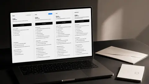 Squarespace's four annual website plan prices displayed on a laptop beside a blank billing envelope and calendar