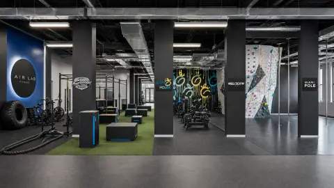 A wide editorial training space combines recognizable zones for AIRLAB Fitness, Miami Freerunning & Parkour Academy, GluteHouse, Velocity Climbing and Miami Pole