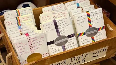 Wrapped mystery books with handwritten clues fill the Blind Date with a Book display at Books & Books in Coral Gables