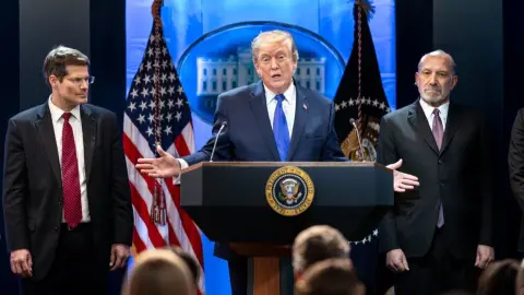 Donald Trump speaks at a White House lectern during tariff remarks in February 2026