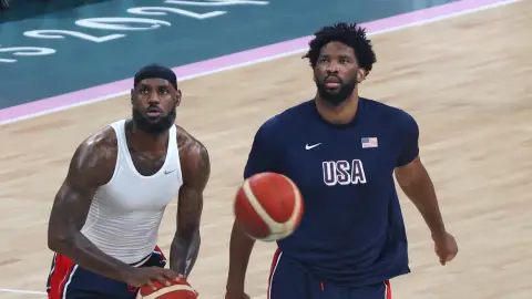 LeBron James and Joel Embiid stand together on a basketball court during the 2024 Paris Olympics.