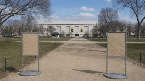 Blank temporary sign frames stand along the walkway leading to the National Museum of American History.