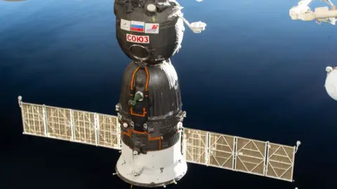 The Soyuz MS-28 spacecraft docked to the International Space Station above Earth