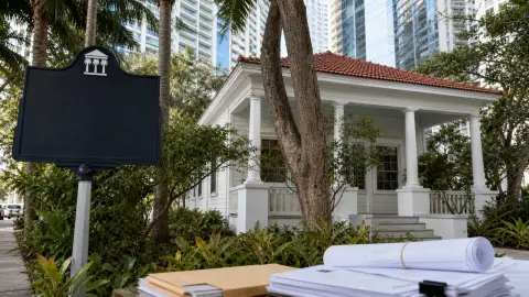 The Dr. James M. Jackson Office in Brickell with city paperwork in the foreground and high-rises behind it.