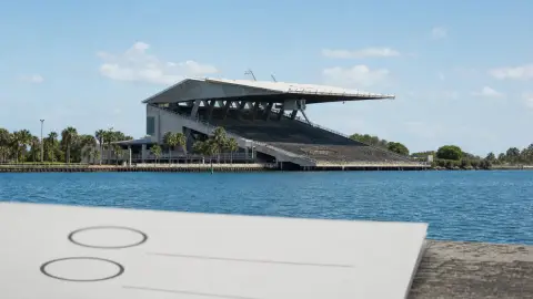 Miami Marine Stadium seen from the water with an anonymous ballot paper in the foreground.