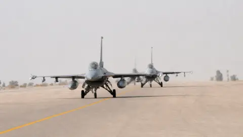 Two F-16 aircraft taxi on a runway at Muwaffaq Salti Air Base in Jordan in a public-domain file image