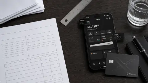 X Money account and card shown beside blank budget paperwork for a consumer finance checklist.