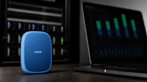 A blue Sandisk storage device beside an abstract earnings screen and server-drive trays.