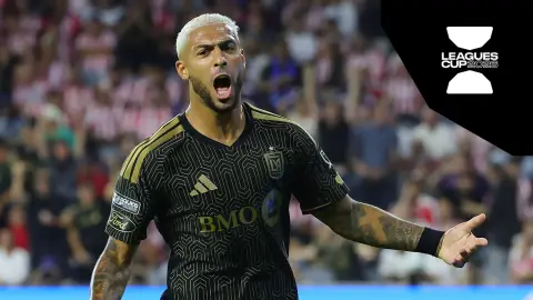 Denis Bouanga in LAFC black and gold during Leagues Cup action with Chivas de Guadalajara supporters blurred behind him