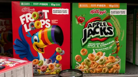 Kellogg's Froot Loops and Apple Jacks boxes on a shelf with a magnifying glass nearby for checking labels.