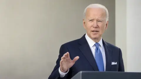 Source-grounded editorial image of Joe Biden speaking in a restrained public setting