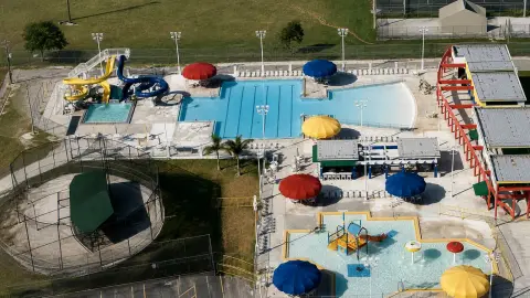 An overhead view of Hialeah's Bucky Dent Water Park with empty pools and waterslides during a safety review