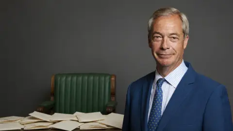 Nigel Farage's official parliamentary portrait beside a restrained field of folded ballot papers and an empty green Commons-style seat
