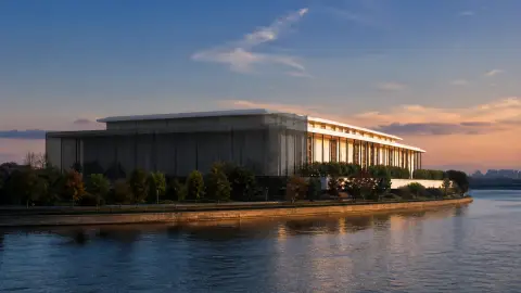 An editorial view of the Kennedy Center beside the Potomac, with most of the building behind a translucent dark veil and one edge left in warm light