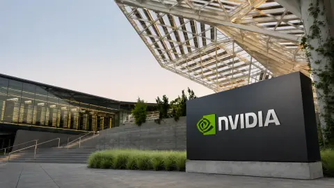 NVIDIA's Voyager campus sign in front of a glass-lined row of AI computing racks